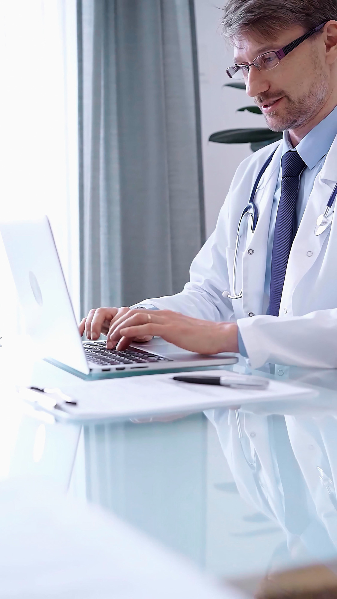 Male Physician White Coat Focused Laptop Data Modern Clinic Office While Analyzing 2